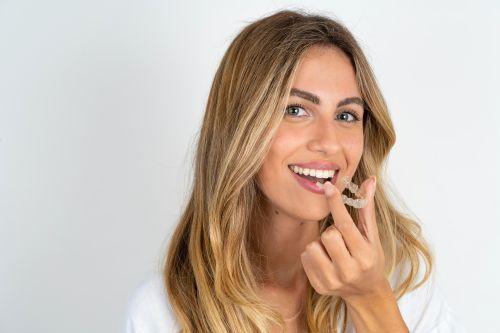 A woman holding Invisalign® Clear Aligners in Wahroonga, NWS