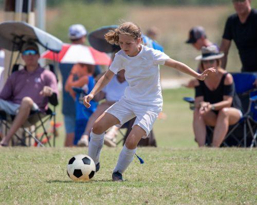 An image of a young girl playing football in Wahroonga, NWS