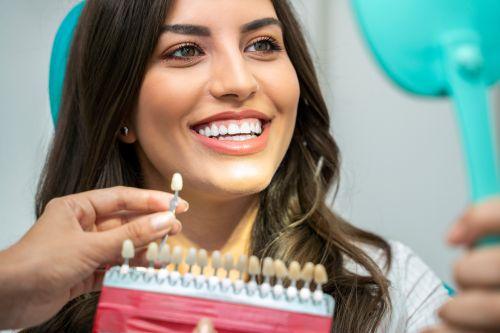 An image of a woman smiling while being shown type of teeth whitening in Wahroonga, NWS