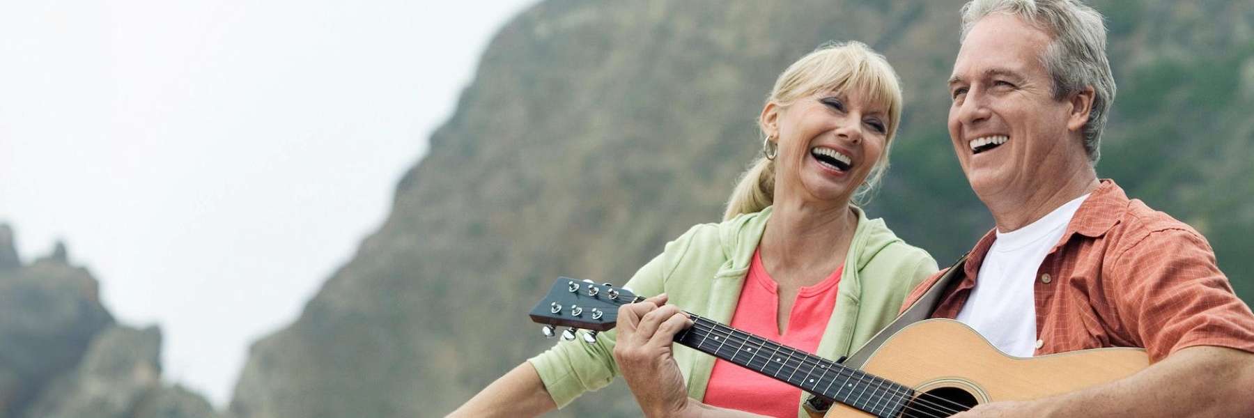 An image showing an elderly couple smiling after replacing missing teeth in Wahroonga, NWS