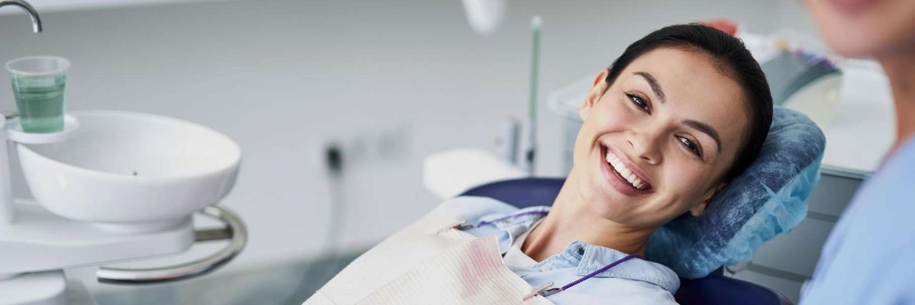 An image of a woman smiling while getting a root canal treatment in Wahroonga, NWS